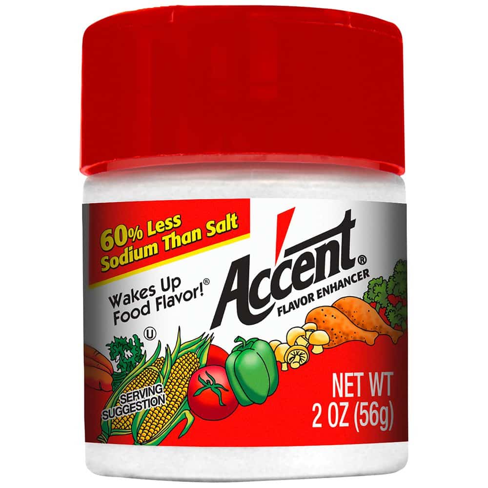 A 2 oz (56 g) container of Accent Flavor Enhancer, promoting 60% less sodium than salt, designed to enhance the natural flavors of food.
