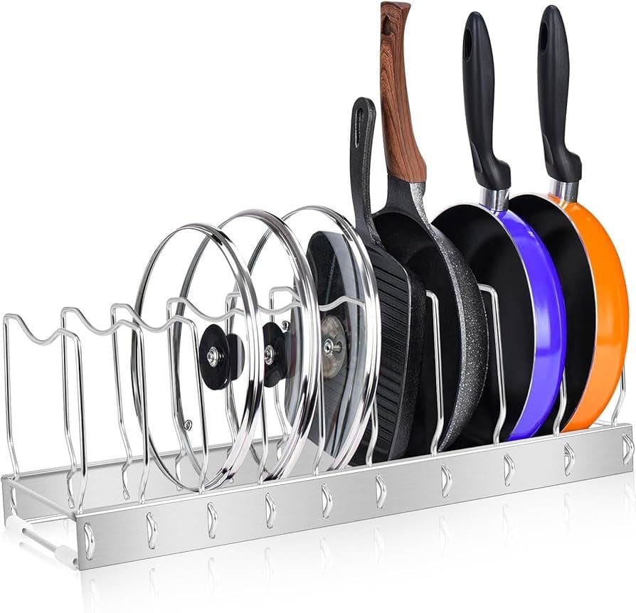 A metal pot and pan organizer rack holding frying pans, grill pans, and pot lids. The adjustable dividers allow flexible spacing to accommodate various cookware sizes, helping to keep kitchen cabinets or countertops neat and organized.