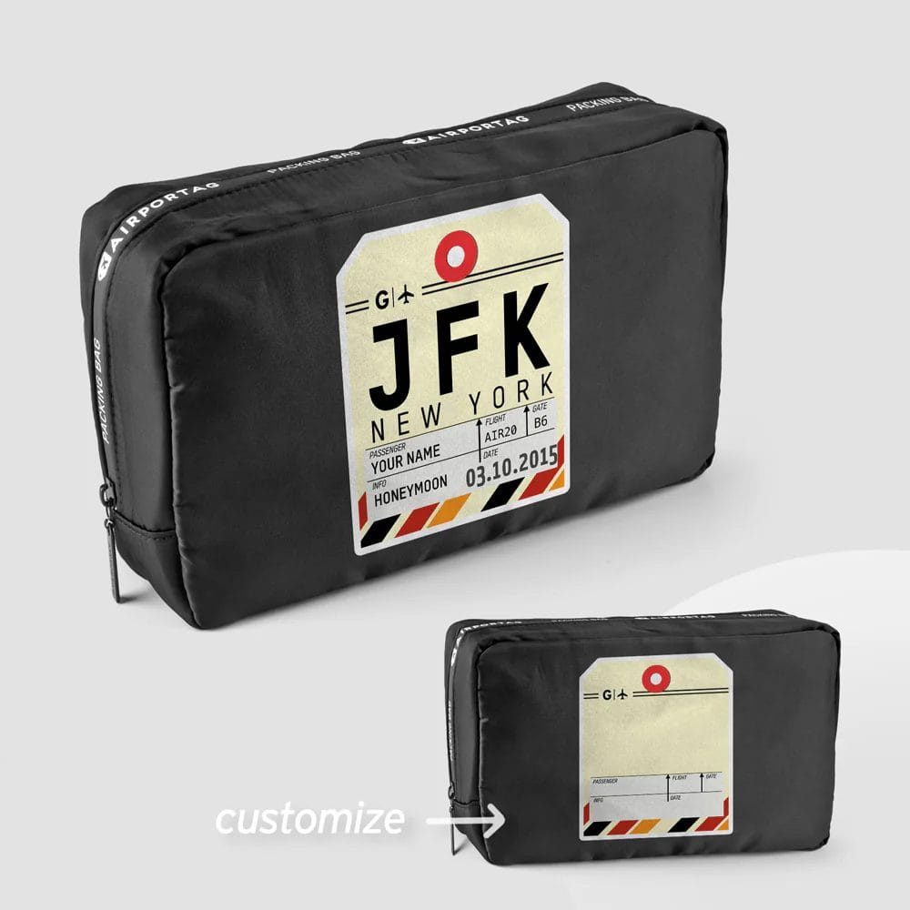 A black travel bag featuring a customizable JFK New York airport tag design with flight details and a honeymoon label, offering a unique, personalized touch