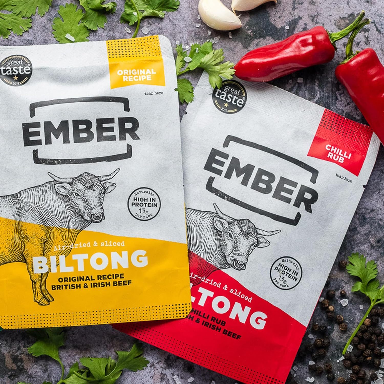 Two bags of Ember Biltong, Original Recipe with yellow packaging and Chilli Rub with red packaging, made from British & Irish beef.