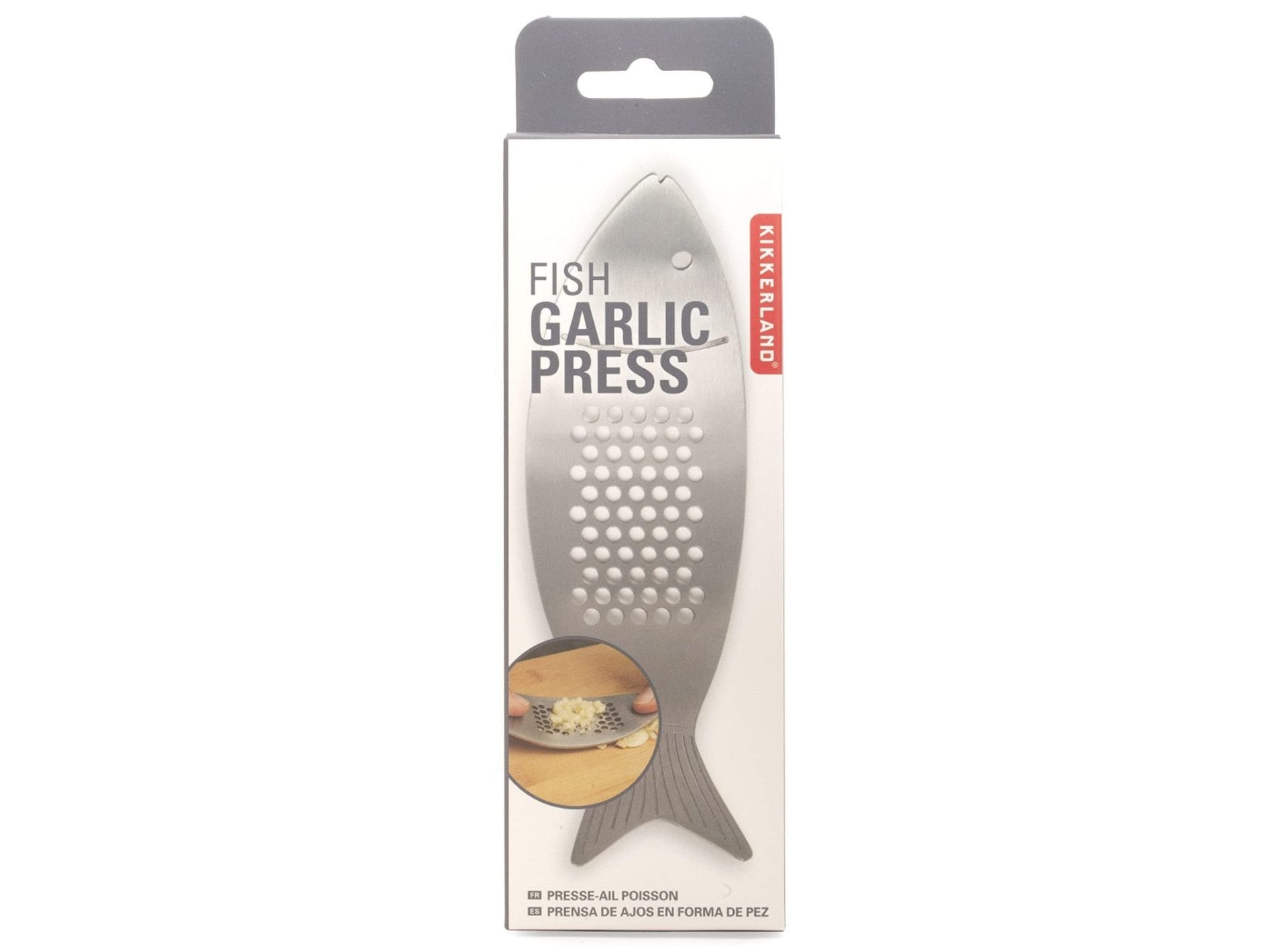 Stainless steel fish-shaped garlic press by Kikkerland in its original packaging. Designed for easily crushing garlic cloves with a sleek, ergonomic shape.