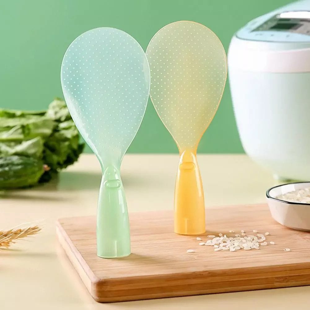 Two standing rice paddles in pastel green and yellow, designed to stand upright on a flat surface. The textured surface prevents rice from sticking, making it easier to serve rice cleanly. Ideal for use with rice cookers